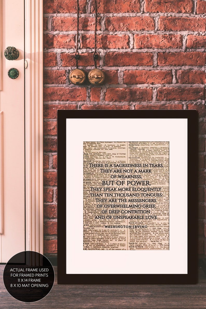 May include: A framed print of a vintage newspaper article with the text "There is a sacredness in tears. They are not a mark of weakness, but of power." The text is attributed to Washington Irving.