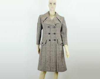 May include: A long, double-breasted coat with a plaid pattern in shades of brown, beige, and black. The coat has a collar, long sleeves, and pockets.
