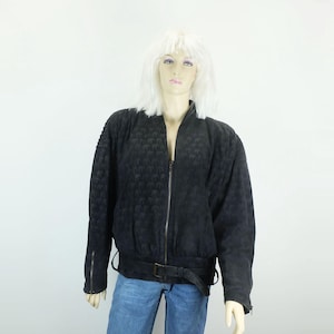 May include: A black quilted bomber jacket with a zipper closure and a belt at the waist.