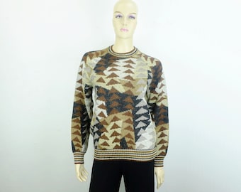 May include: A brown, beige, and black geometric patterned sweater. The sweater has a crew neck and long sleeves.