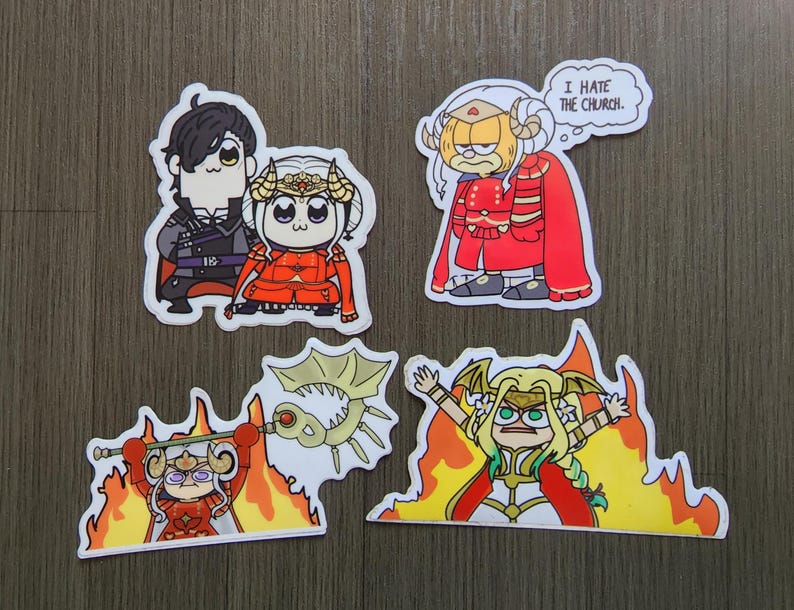 Puede incluir: Un conjunto de cuatro pegatinas de dibujos animados con personajes en varias poses. Una pegatina muestra dos personajes, otra presenta un personaje con un bocadillo que dice "I HATE THE CHURCH". Las otras dos pegatinas muestran personajes con llamas.