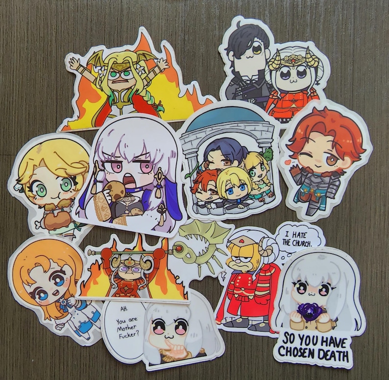 Puede incluir: Una colecci&oacute;n de pegatinas coloridas de estilo anime con varios personajes. Algunas pegatinas tienen texto, incluyendo "I HATE THE CHURCH", "AH You are Mother Fucker?" y "SO YOU HAVE CHOSEN DEATH". Las pegatinas est&aacute;n sobre una superficie de madera.