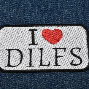 May include: White patch with black border on a blue denim background. The patch has a red heart and the text "I love DILFS".