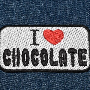 May include: White patch with black embroidered text "I love chocolate" and a red heart.