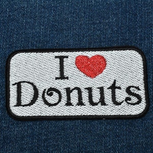 May include: White patch with black embroidered text "I love Donuts" and a red heart.
