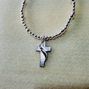 American Flag draped over a Sterling Silver Cross