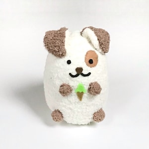 May include: White plush dog toy with brown ears and a brown spot on its face. The dog is holding a green ice cream cone.