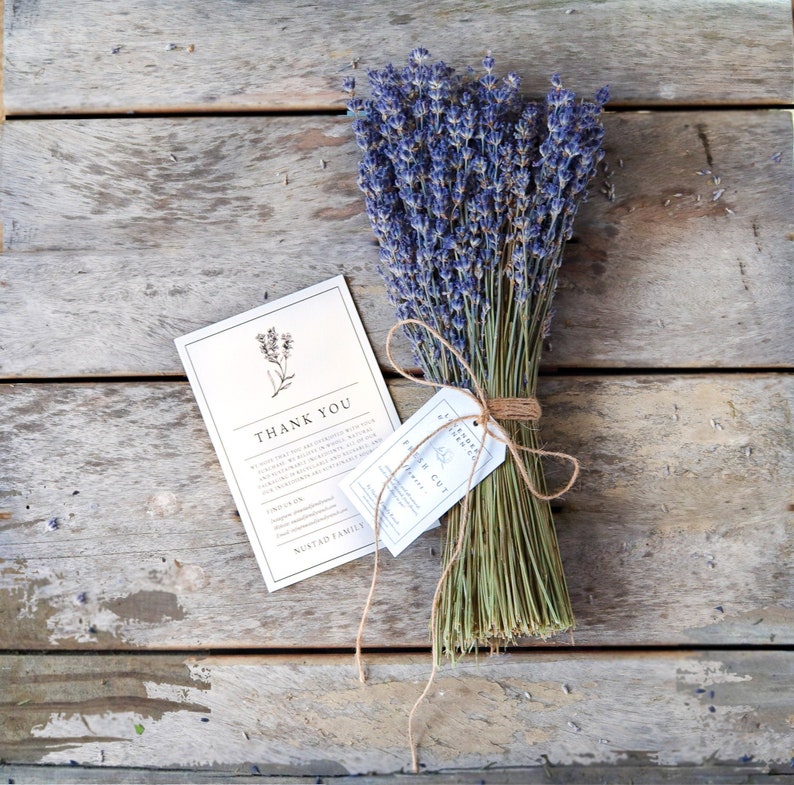 May include: A bouquet of dried lavender tied with twine and a small white tag that says "Thank You" and "Nustad Family".