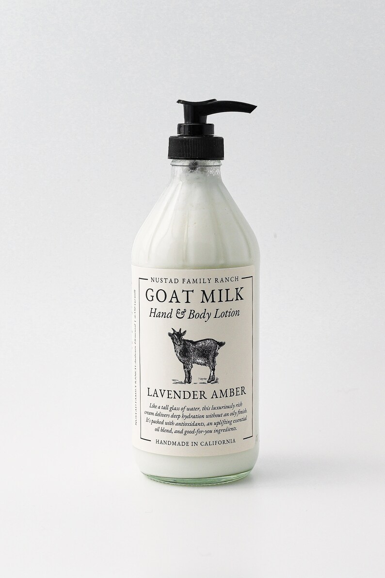 May include: A white bottle of goat milk hand and body lotion with a black pump top. The bottle has a white label with black text that reads "NUSTAD FAMILY RANCH GOAT MILK Hand & Body Lotion LAVENDER AMBER Like a tall glass of water, this luxuriously rich cream delivers deep hydration without an oily finish. It's packed with antioxidants, an uplifting essential oil blend, and good-for-you ingredients. HANDMADE IN CALIFORNIA".