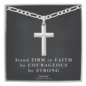 May include: A silver chain necklace with a cross pendant. The pendant has a textured design. The box the necklace comes in has the text "Stand FIRM in FAITH be COURAGEOUS be STRONG inspired by my girls STERLING SILVER 925".