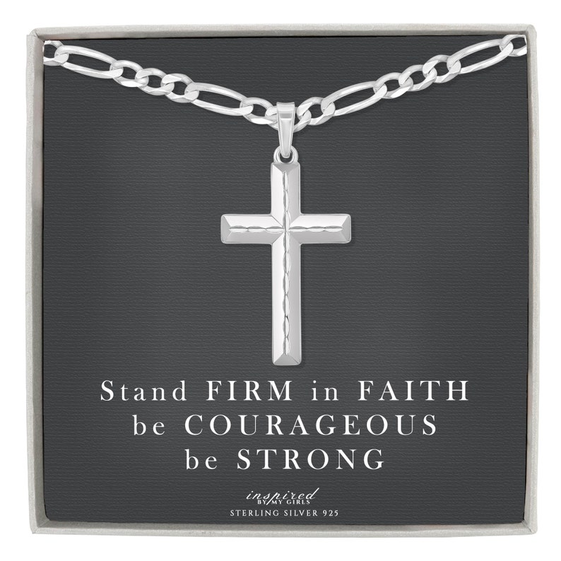 May include: A silver chain necklace with a cross pendant. The pendant has a textured design. The box the necklace comes in has the text "Stand FIRM in FAITH be COURAGEOUS be STRONG inspired by my girls STERLING SILVER 925".