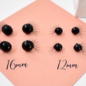 May include: Close-up of eight black round buttons with a fringe of black fibers around the edges. The buttons are arranged in two rows, with the top row labeled "16mm" and the bottom row labeled "12mm".
