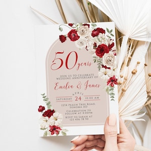 May include: A 50th wedding anniversary invitation card with floral accents. The card features the names "Emilia & James" and event details. The design includes red and white flowers and the text "50 years".