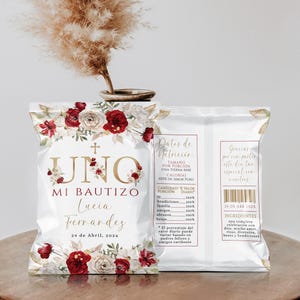 May include: A custom chip bag favor for a baptism featuring a floral design with red and white roses, a gold cross, and the text "UNO MI BAUTIZO Lucia Fernandez 24 de Abril, 202x". The back includes a nutrition facts label with "Datos de Nutrición" and "Gracias".