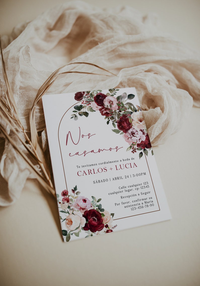 May include: A wedding invitation with a floral design in shades of pink and burgundy. The invitation reads "Nos casamos" and includes the names Carlos and Lucia, the date Saturday, April 24, and the time 3:00 PM. The invitation also includes the address and contact information for RSVP.