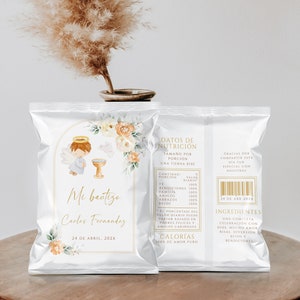 May include: Two white cellophane bags with gold text and illustrations. The front bag reads "Mi bautizo" with a cartoon angel and floral accents. The back bag has nutrition facts and ingredients. The date "24 de Abril, 202X" is printed on both bags.