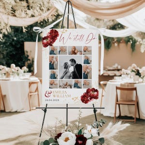 May include: A wedding welcome sign on a black easel. The sign features a collage of photos, the words "We still Do" in burgundy script, and the names "Emilia & William" with a date. Burgundy floral accents decorate the sign.