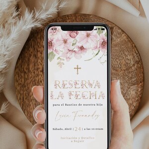 May include: A smartphone screen displaying a floral design with a gold cross and the text "RESERVA LA FECHA" for a baptism. The text also includes the name "Lucia Fernandy", the date "Sábado, Abril 24", and the time "a las 10:00am".