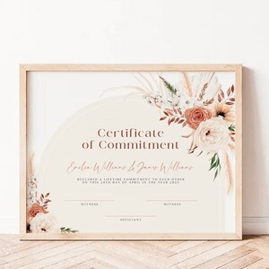 May include: A certificate of commitment with a floral design in shades of peach, white, and brown. The text reads "Certificate of Commitment" and "Emlen Williams & James Williams" with the date "24th day of April in the year 202X".