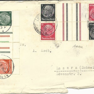 May include: A vintage envelope with several German stamps featuring portraits of historical figures. The stamps are in various colors, including red, green, and black. The envelope is addressed to a person in Luzern, Switzerland.