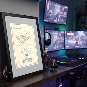 May include: A black framed wall art print featuring a vintage-style technical patent illustration of a graphics card on aged, beige paper. The drawing includes detailed schematics, technical lines, and text labels, presented in a clean, professional display.