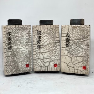 Raku box with Chinese scripts, 16cm high, by Nathalie Hamill