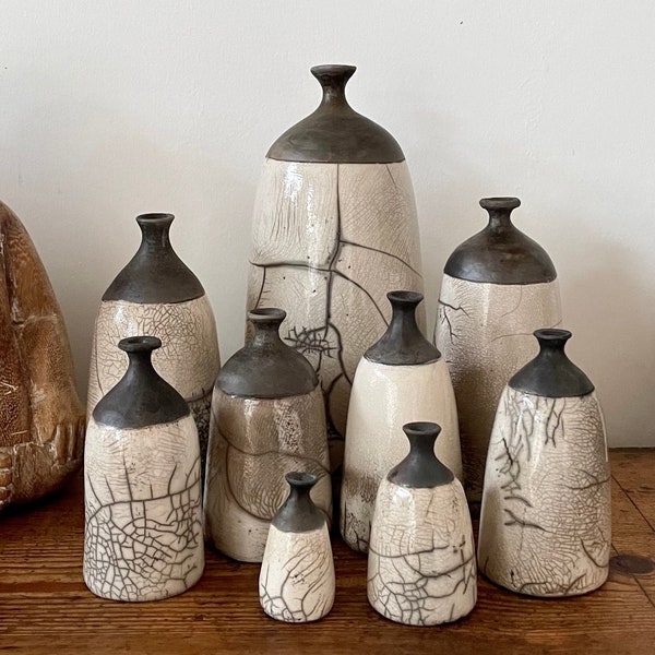 Tall black and white Raku bottles  by Nathalie Hamill