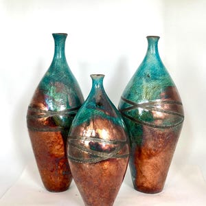 Turquoise Raku tall bottles with copper reduction by Nathalie Hamill