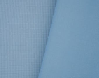 May include: A solid light blue fabric with a fine, uniform grid texture. The material is folded, creating a diagonal line that separates a flat section on the left from a draped, slightly shadowed section on the right, showcasing the weave.