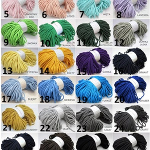 May include: A collection of 32 spools of cotton cord in various colors, including white, beige, pink, green, yellow, blue, gray, black, red, and purple. Each spool is labeled with a number and a color name in Polish.