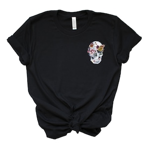 May include: Black t-shirt with a floral skull design on the front.