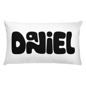 May include: White rectangular pillow with the name "DANIEL" written in black, stylized letters.
