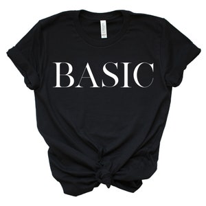 May include: A black t-shirt with the word "BASIC" printed in white on the front.
