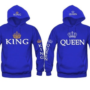 May include: A pair of blue hoodies with white text and gold crowns. The left hoodie says "KING" and the right hoodie says "QUEEN".