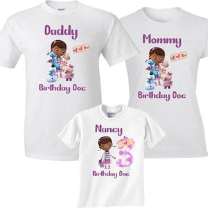 May include: Three white t-shirts with a purple design featuring Doc McStuffins, a cartoon doctor. The shirts say "Daddy of the Birthday Doc", "Mommy of the Birthday Doc", and "Nancy the Birthday Doc".