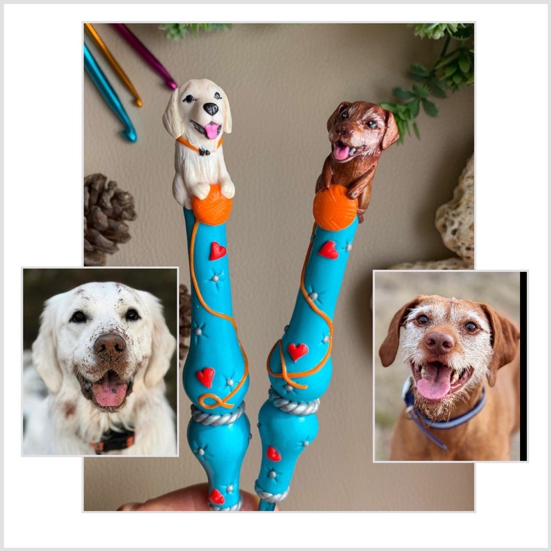 May include: Two handmade crochet hooks with dog toppers. One hook has a white dog with brown spots and a red heart on its chest. The other hook has a brown dog with a red heart on its chest. Both hooks are blue with orange and white accents.