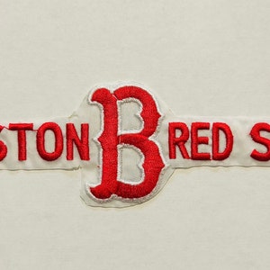 May include: Red embroidered patch with the words "BOSTON RED SOX" and a large red "B" in the centre.