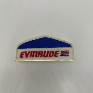 May include: A white, blue, and red embroidered patch with the text "EVINRUDE" in red.