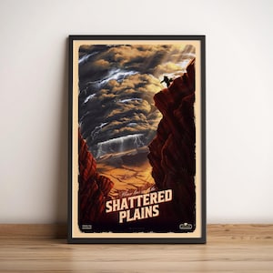 May include: Framed art print featuring a dramatic landscape with a person on a cliff edge. The artwork depicts a stormy sky above a canyon, with the words "SHATTERED PLAINS" in bold letters. The print is in a black frame.