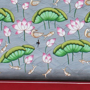 May include: A hand-painted illustration of a pond scene with pink lotus flowers, green lily pads, and gold fish swimming in the water. The background is a light blue with a wavy pattern.