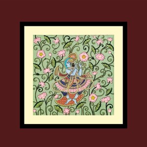 May include: A framed artwork showing a blue-skinned figure playing a flute, set amongst pink lotus flowers and green foliage on a light green backdrop. The figure wears colourful clothes with gold details. The artwork is framed in black.