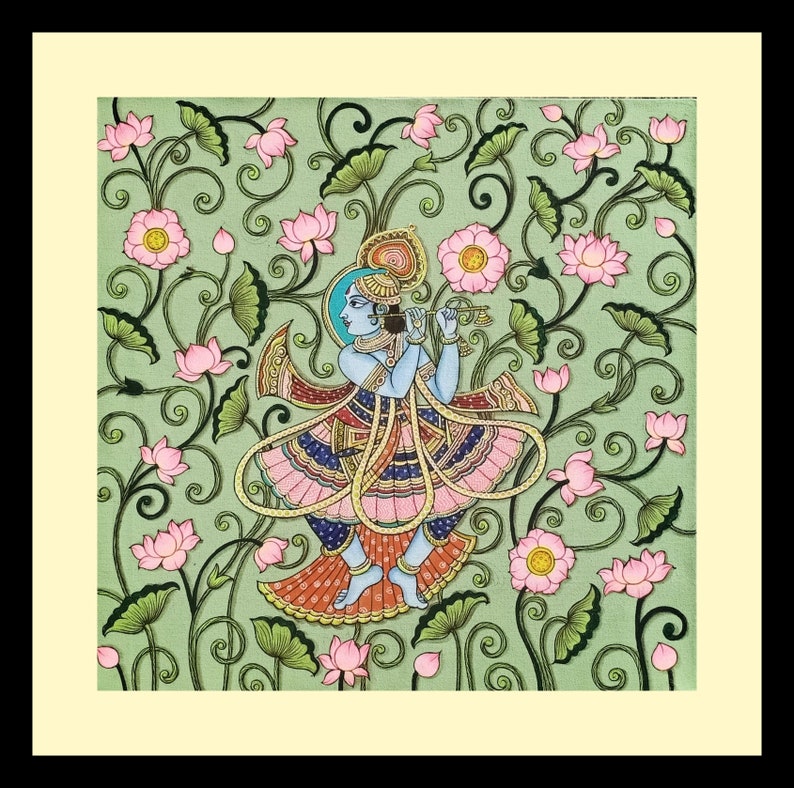 May include: An Indian artwork showing a blue-skinned figure playing a flute, set against a backdrop of pink lotus flowers and green foliage on a light green canvas. The figure wears colourful traditional attire. The artwork is framed in a cream-coloured border.