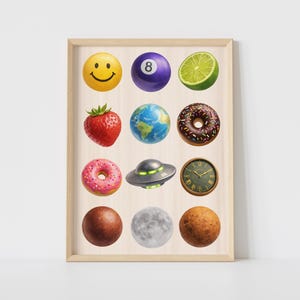 May include: A framed print featuring a collection of colorful, illustrated objects. The objects include a smiley face, an eight ball, a lime, a strawberry, a globe, a donut, a pink donut, a UFO, a clock, a brown ball, a moon, and a planet.
