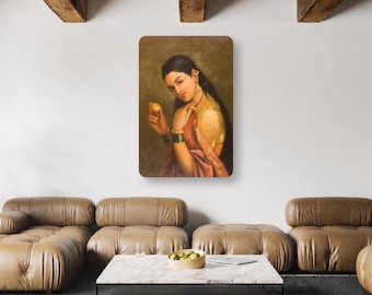 May include: A rectangular wall art print featuring a classical oil painting of a person with long dark hair, wearing a yellow blouse and a pink sari, holding a small yellow fruit. The figure is adorned with dark green bangles and gold jewelry.