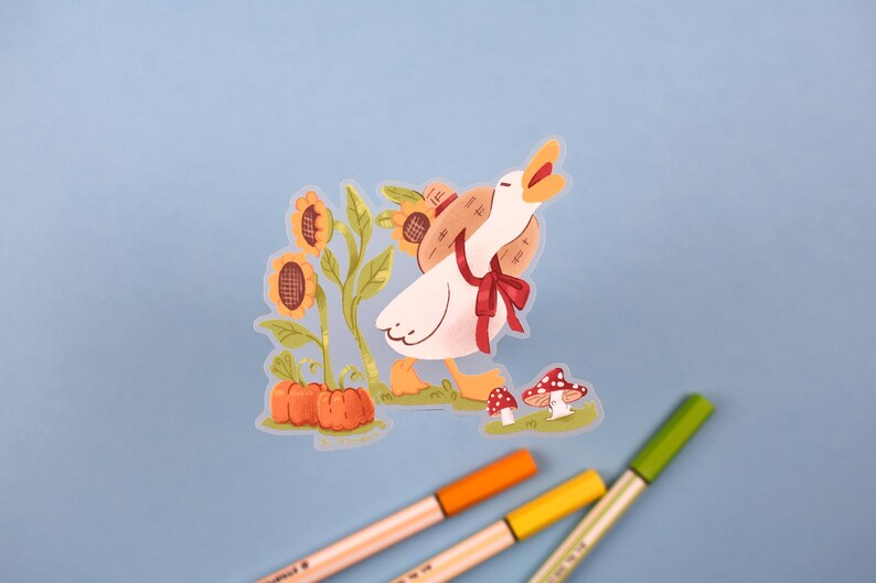 May include: A white goose with a red bow and a straw hat is walking towards a patch of sunflowers and pumpkins. The goose is carrying a basket of sunflowers on its back.