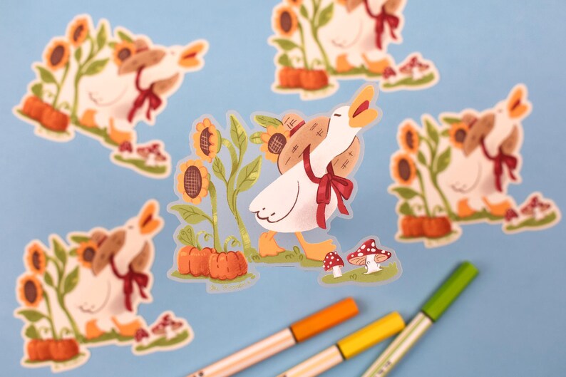 May include: A set of five stickers featuring a cartoon goose wearing a straw hat and carrying a basket of sunflowers. The goose is depicted in various poses, including walking, standing, and looking up. The stickers are printed on clear vinyl and have a glossy finish.