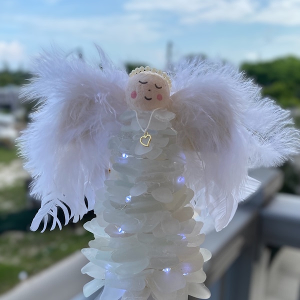 Precious 7.25 inch lighted white sea glass guardian angel with feather wings,spun cotton head,pearl halo and heart necklace. Centerpiece.