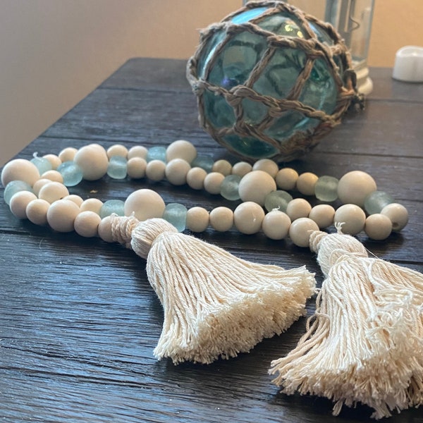 36 inch Aqua sea glass type and wood bead garland with cotton tassels. Glass beads handmade in Africa. Dough bowl option prayer bowl