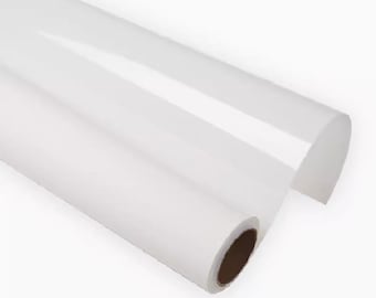 May include: A roll of clear, transparent vinyl film. The film is rolled up and has a brown core.