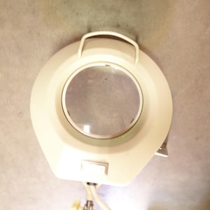 May include: Off-white magnifying lamp with a circular lens and a handle. The lamp has a rectangular switch and is mounted on a flexible arm. The base is not visible in the image.